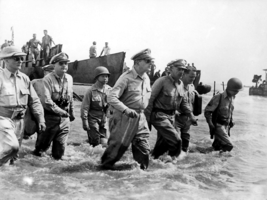 General Douglas MacArthur and his staff wading ashore through shallow surf at Leyte, October 1944.